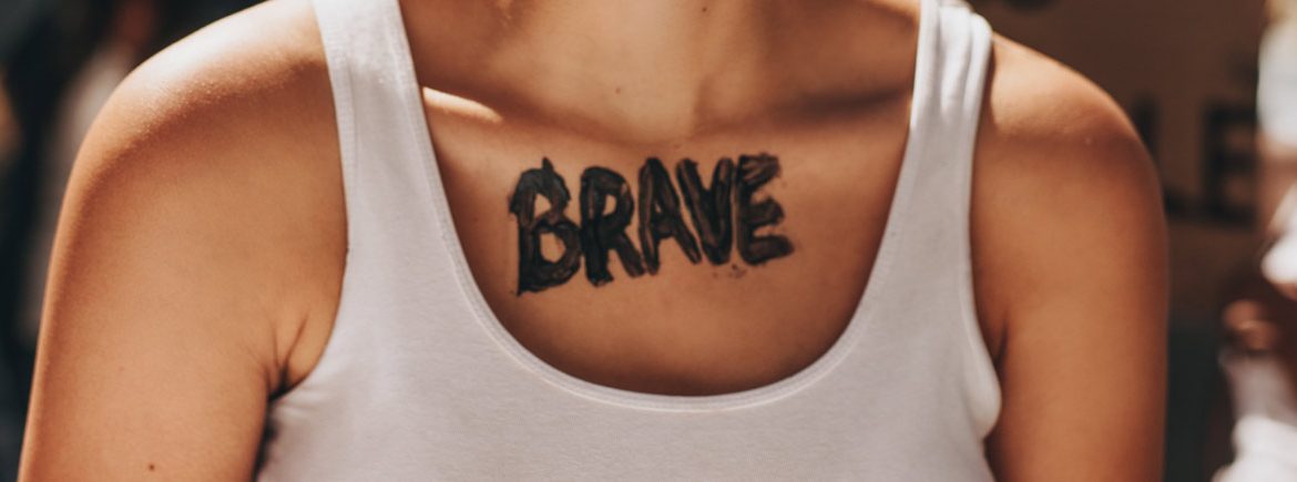 Un tatuaggio sul petto con la scritta Brave, coraggio
